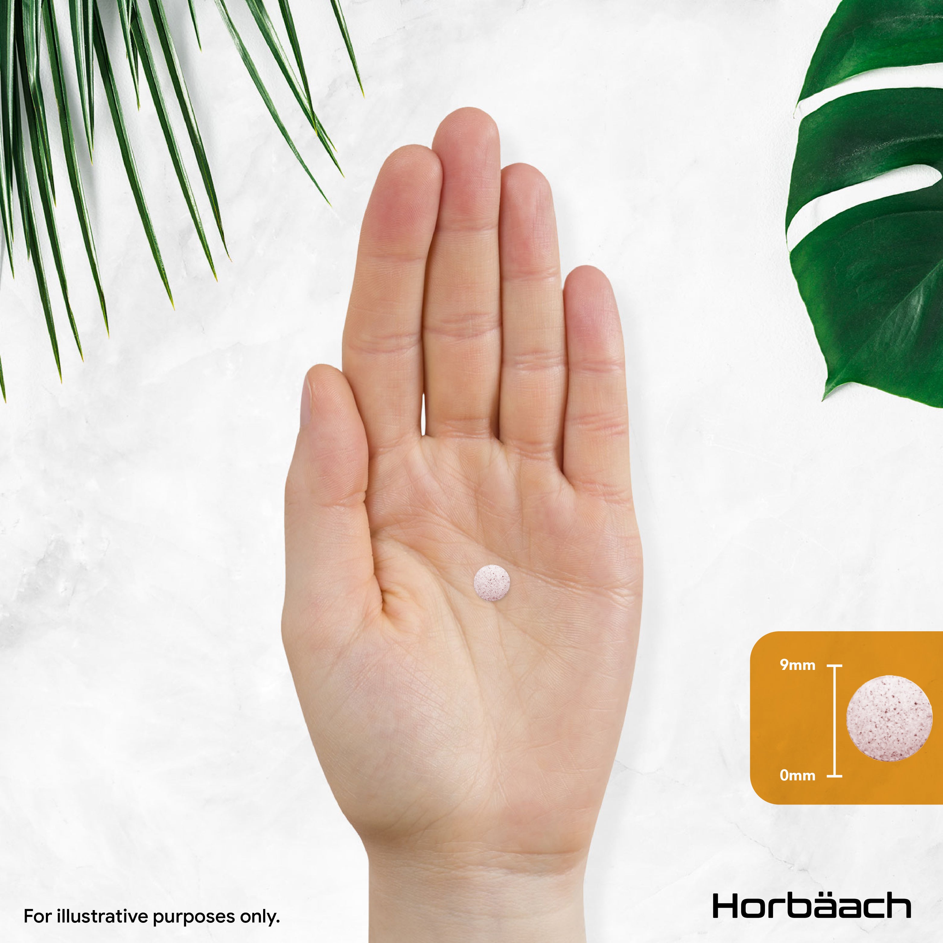 Small, round, light pink speckled tablet on an open palm with a graphic indicating a 9mm diameter.