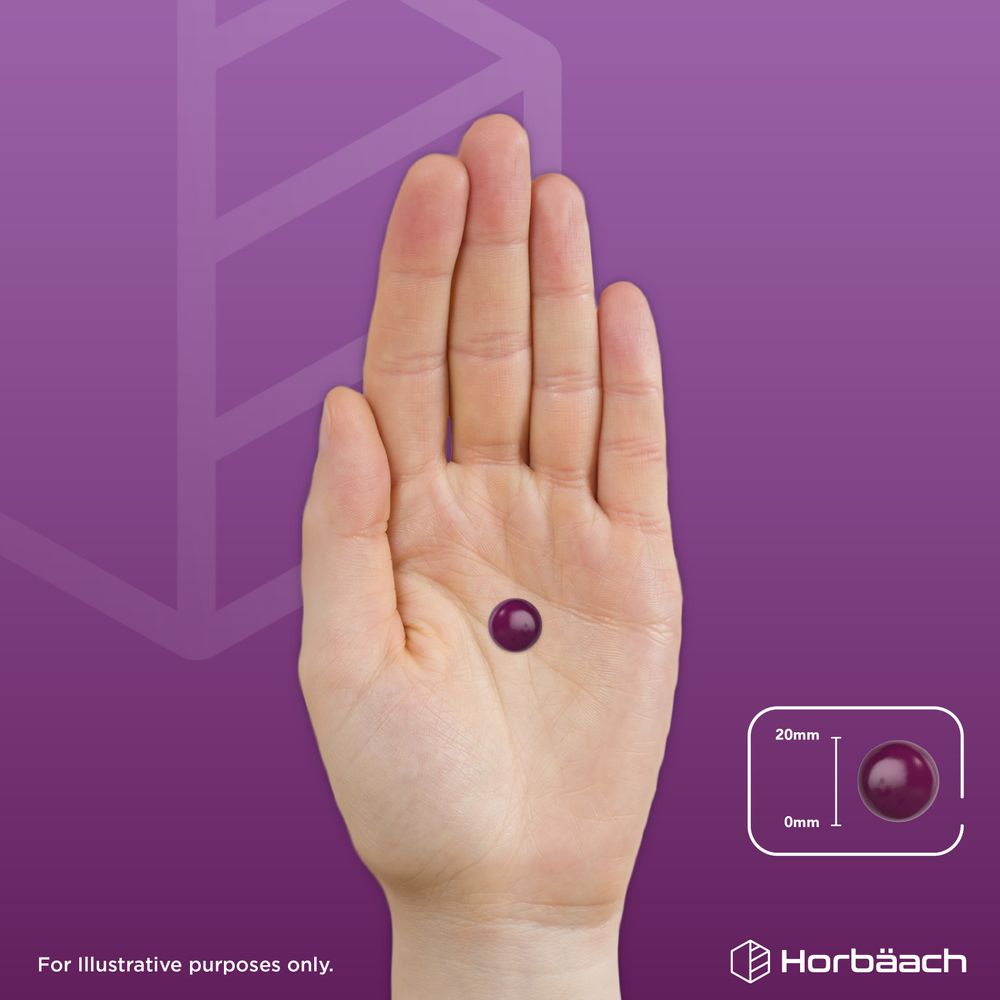 A hand holds a single dark purple Black Elderberry gummy, measuring 20mm.