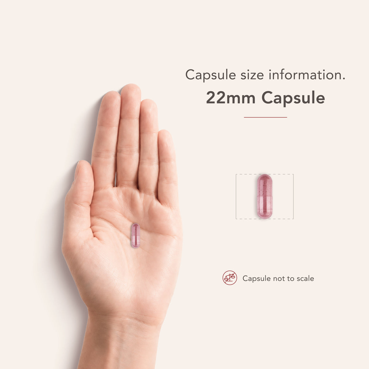A hand holds a pink 22mm capsule, magnified to show speckled contents inside, fitting the bulk scale theme.