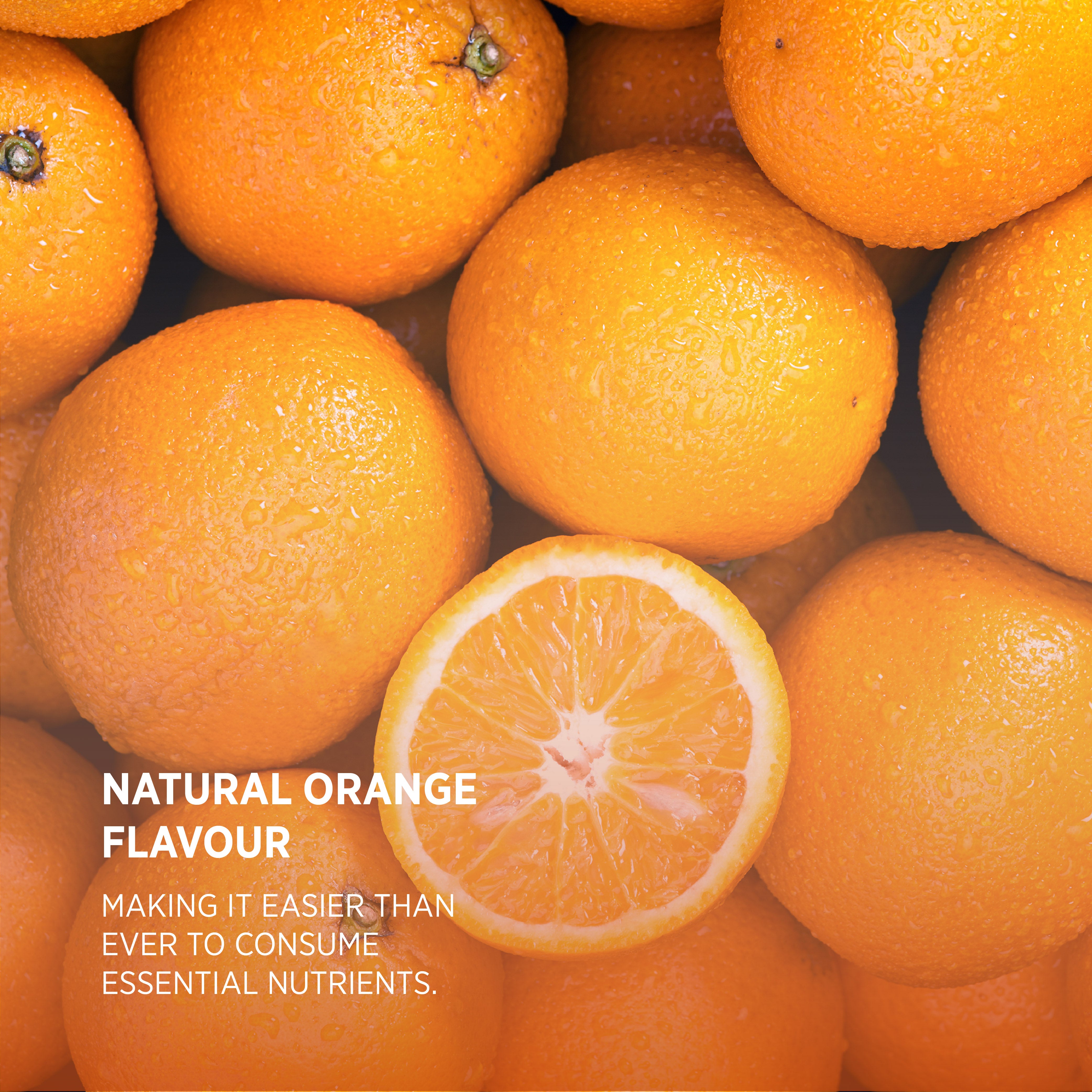 Fresh, wet oranges, one halved with text 'NATURAL ORANGE FLAVOUR' displayed on a product label.