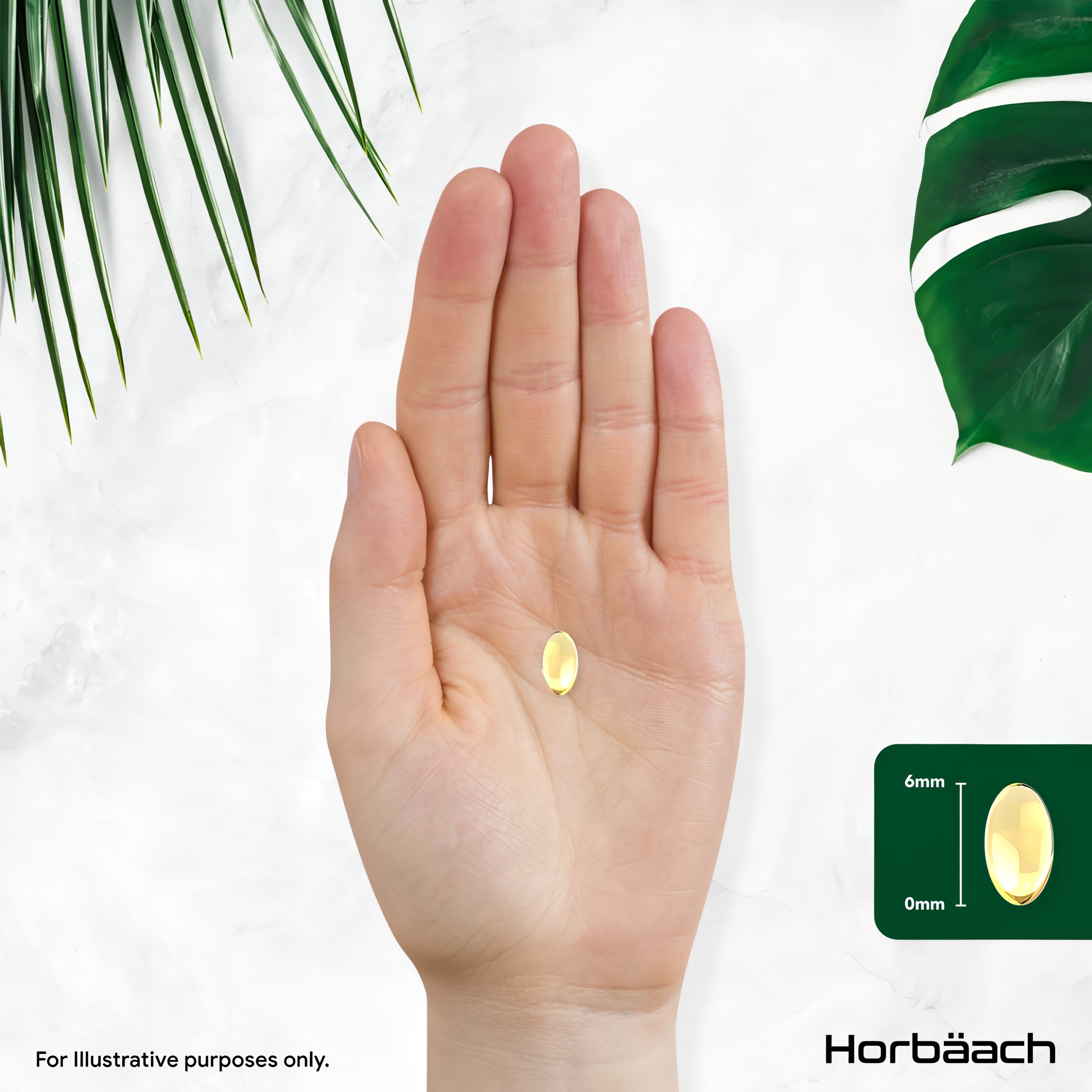 A hand holds a single yellow 6mm softgel.
