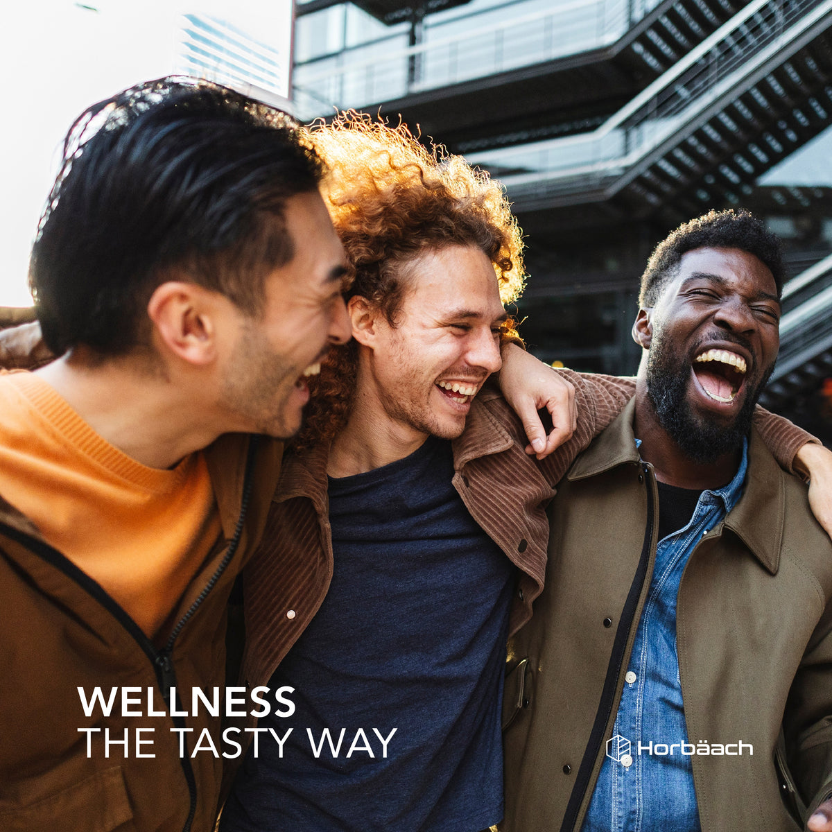 Three diverse young adult men laughing and embracing, featured for Men's Multivitamin Gummy.